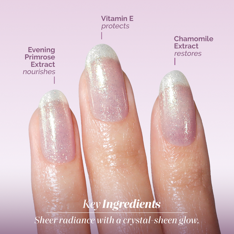 Three manicured nails with sheer, glittery polish showcase LONDONTOWN’s Shimmering Nail Highlighter - Sunkissed, featuring Evening Primrose Extract, Vitamin E, and Chamomile Extract for nourishment and soothing benefits.