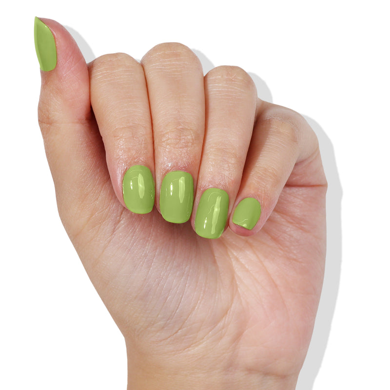 A hand with short, neatly manicured nails painted in a glossy, Tipsy Mermaid green polish by LONDONTOWN.