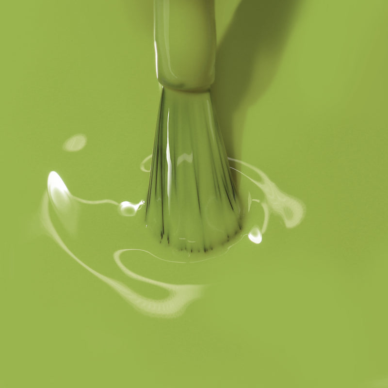 A brush is dipped in a pool of LONDONTOWN's Tipsy Mermaid paint, causing ripples.