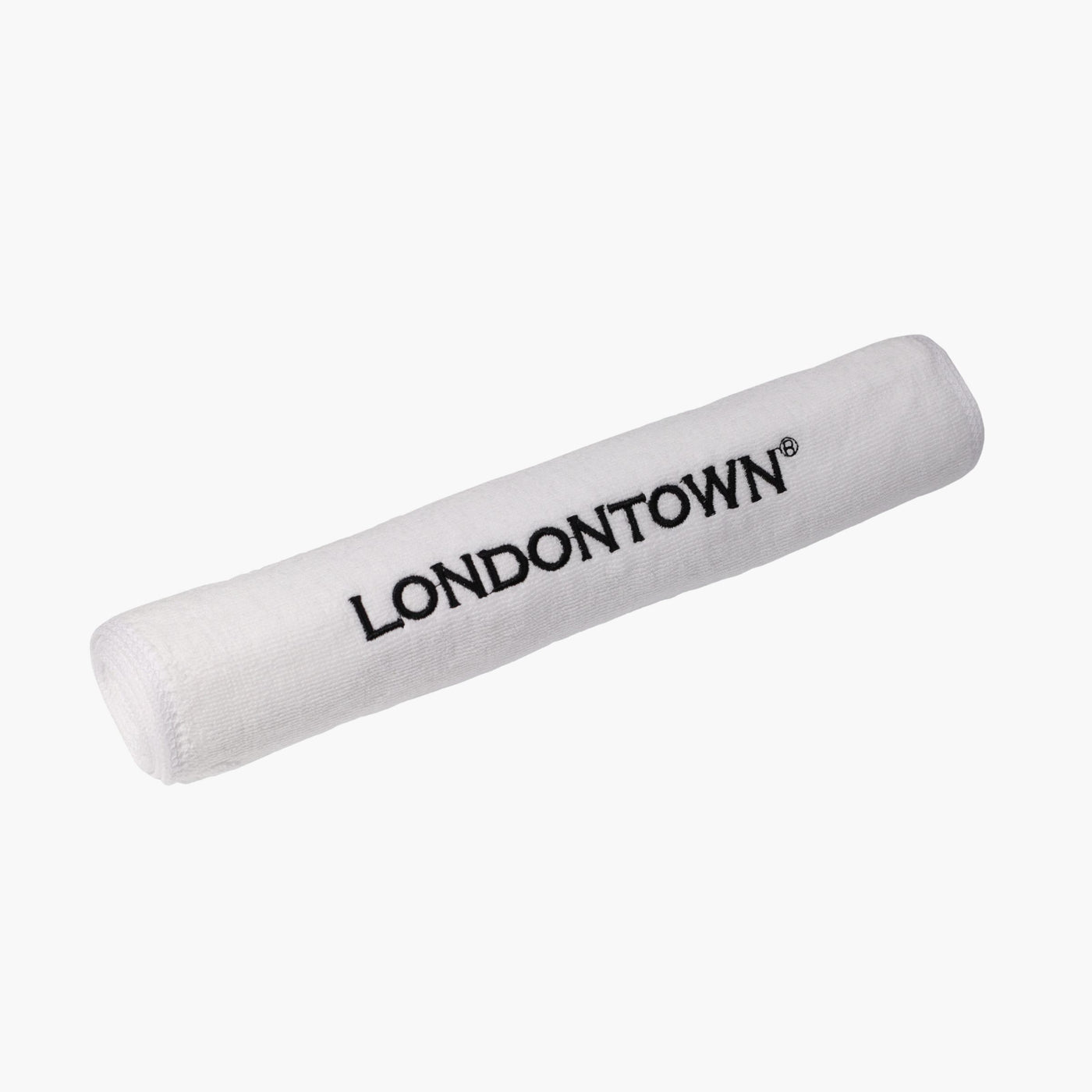 A white Londontown Towel rolled up, featuring the brand name "LONDONTOWN" in black capital letters on its side.
