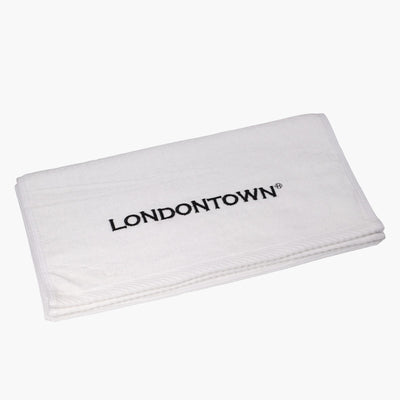 A folded white Londontown Towel with the brand name "LONDONTOWN" embroidered in black.