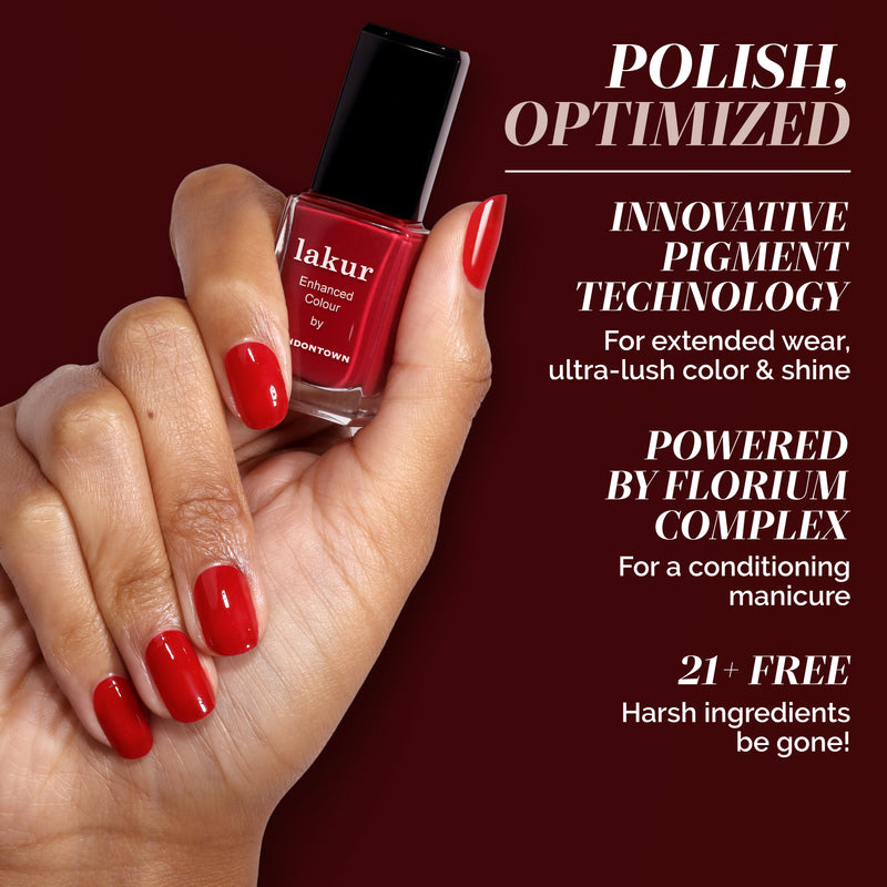 A hand with neatly manicured Truly Ruby nails holds a bottle of LONDONTOWN polish against a brown background, with product features listed alongside.