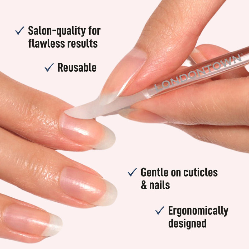 A hand carefully pushes back cuticles using a LONDONTOWN Glass Cuticle Pusher. This salon-quality, reusable tool is gentle on cuticles and nails, and ergonomically designed.