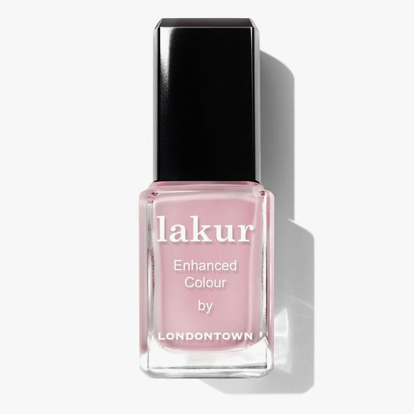A bottle of Magnolia Haze nail polish with a black cap from LONDONTOWN's "lakur Enhanced Colour" collection offers an effortlessly versatile touch to your manicure.