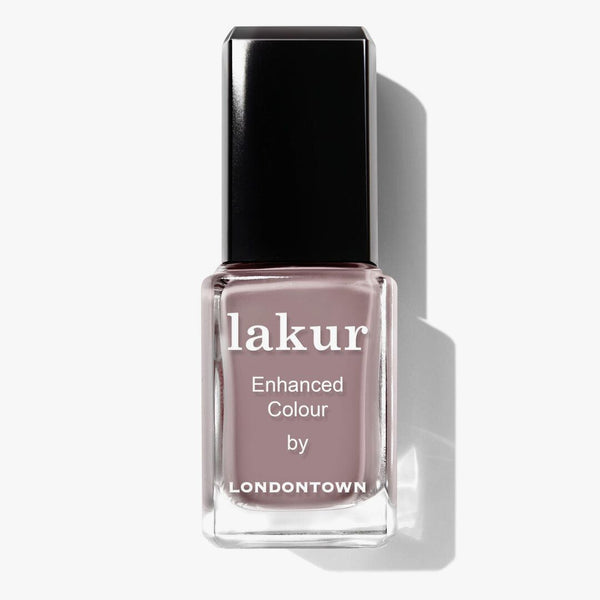 A bottle of LONDONTOWN's Lakur nail polish, "Do Not Disturb," features a taupe shade with mauve undertones and a black cap.