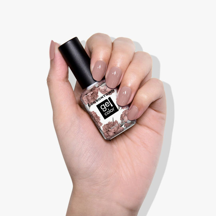 A hand confidently holds a LONDONTOWN gel polish bottle labeled &