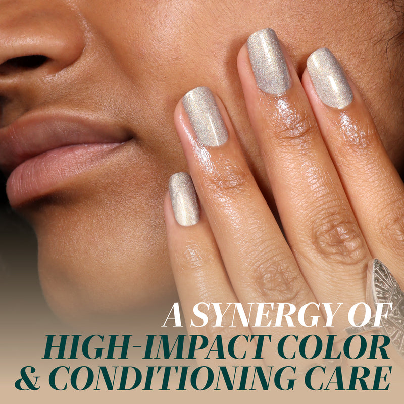 A close-up of a person’s face and hand flaunting LONDONTOWN’s You're Golden shimmery holographic gold nail polish, with the text: “A synergy of high-impact color & conditioning care.”.