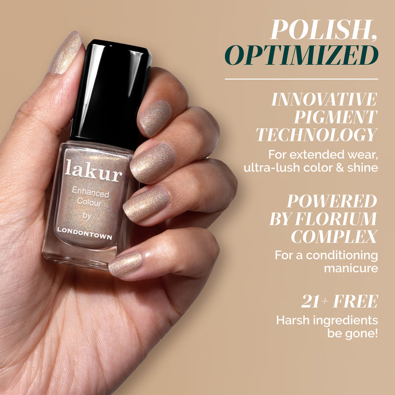 A hand with shimmery nude nails holds a LONDONTOWN You're Golden bottle; text highlights its holographic gold finish and nourishing formula.