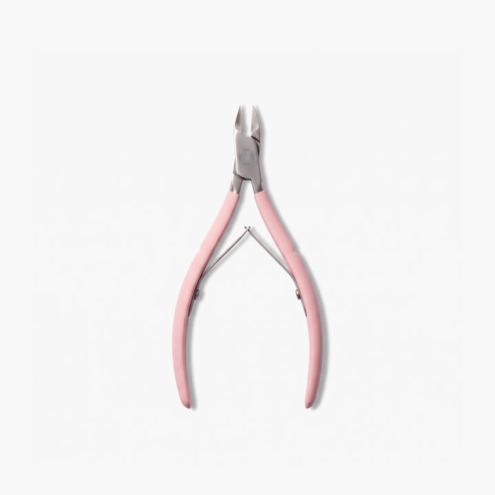 A pair of LONDONTOWN Cuticle Nippers in pink is displayed on a white background, offering salon-grade precision and effortless grooming.