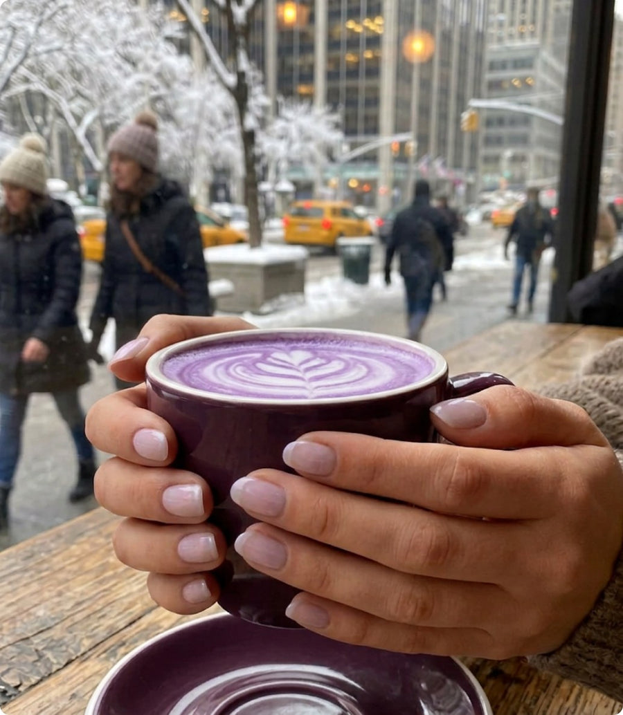 Hands with lavender nails holding a lavender latte