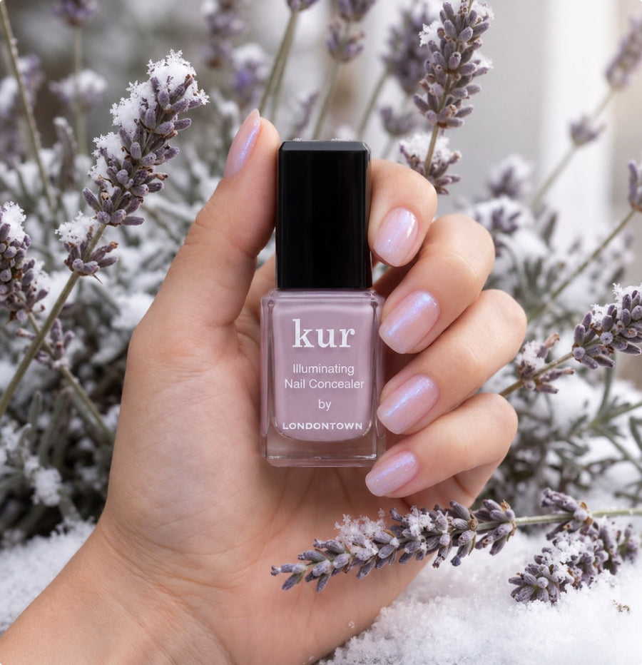 Lavender Illuminating Nail Concealer held among frosted lavender