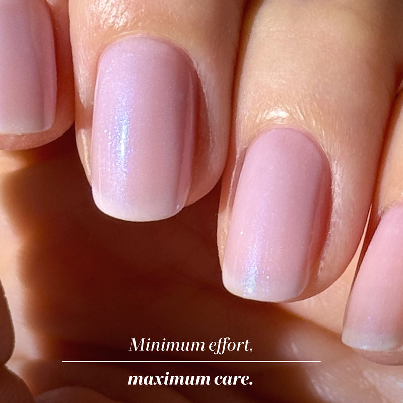 Close-up of a hand with neatly manicured, pale pink nails; text at the bottom reads, "Minimum effort, maximum care," thanks to LONDONTOWN's Lavender Illuminating Nail Concealer that perfects and enhances your nails' beauty.