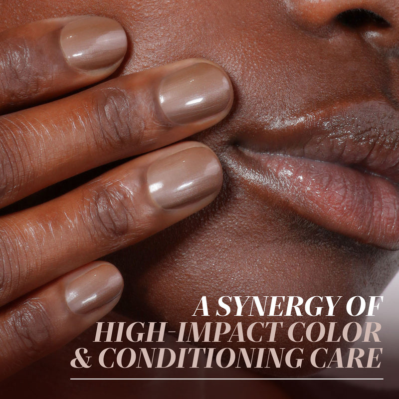 Close-up of a person’s hand with neatly manicured taupe nails in the shimmering java shade “Affogato” by LONDONTOWN touching their face, with the text: “A synergy of high-impact color & conditioning care.”.