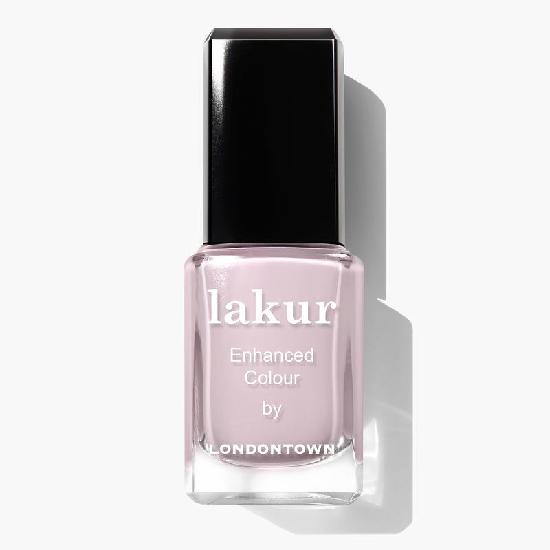 A bottle of LONDONTOWN Lakur nail polish with a black cap, labeled "Afternoon Tea" in a warm and cozy light pink crème shade.