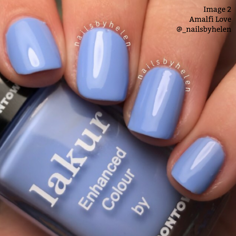 Four nails painted in a glossy cool blue tone. A bottle of Lakur Enhanced Colour nail polish by LONDONTOWN, known for being vegan, cruelty-free, and 16+ Free, is visible with the shade name Amalfi Love.