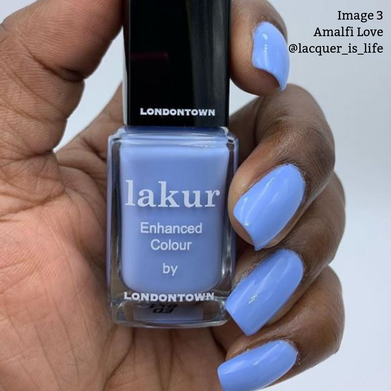 A hand with blue painted nails holds a bottle of LONDONTOWN lakur nail polish in the "Amalfi Love" color. Text on the image reads: "Image 3 Amalfi Love @lacquer_is_life." This shade features a cool blue tone and is 16+ Free, vegan, and cruelty-free.