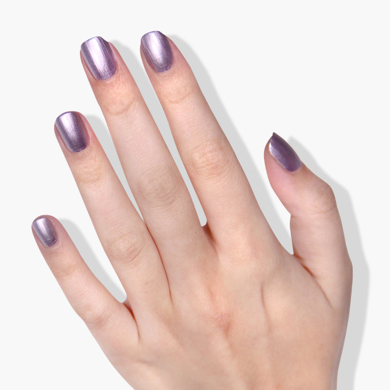 A hand with pale skin displays BRILL-ant metallic-rose nail polish by LONDONTOWN on all five fingernails, showcasing a stunning vegan, cruelty-free option.