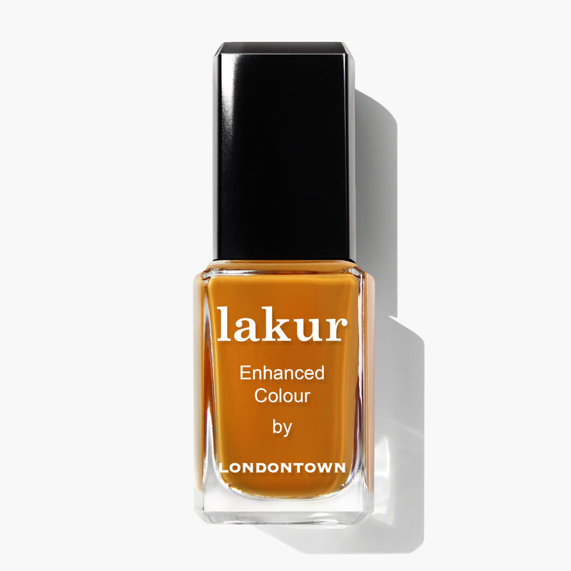 A bottle of Lakur nail polish in the robust goldenrod shade called "Bee's Knees," with a black cap and the text "lakur," "Enhanced Colour," and "by LONDONTOWN" on the front.