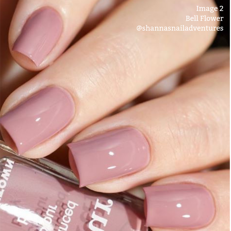 Close-up of hands holding a bottle of nail polish. The nails are painted in a glossy, romantic dusty pink shade reminiscent of an English countryside fairytale. Text overlay reads "Image 2 Bell Flower LONDONTOWN @shannasnailadventures.