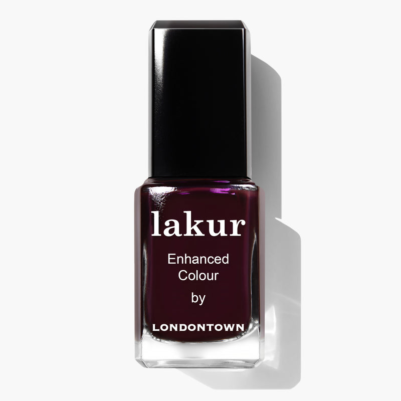 A bottle of LONDONTOWN's Bell in Time Lakur Enhanced Colour nail polish with a black cap and deep maroon shade, featuring a restorative Florium Complex for healthier nails.