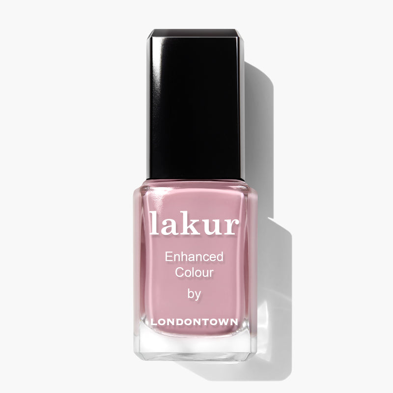 A bottle of LONDONTOWN Berry Nude nail polish in a light pink shade, reminiscent of a delectable blend of whipped cream and blueberries.