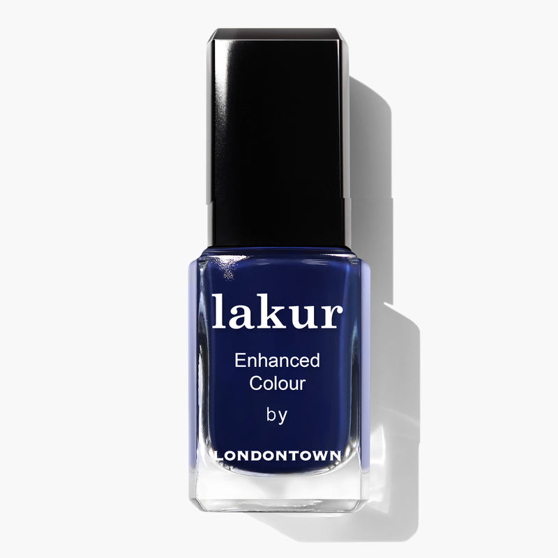 A bottle of dark blue nail polish with the label "Buckingham Blue by LONDONTOWN" on a white background, showcasing a stunning Navy Blue Vegan Nail Polish that's cruelty-free.