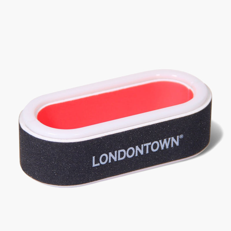 The LONDONTOWN Nail Buffer is a rectangular, black tool with white sides and a red center, making it perfect for achieving a salon-worthy manicure at home.