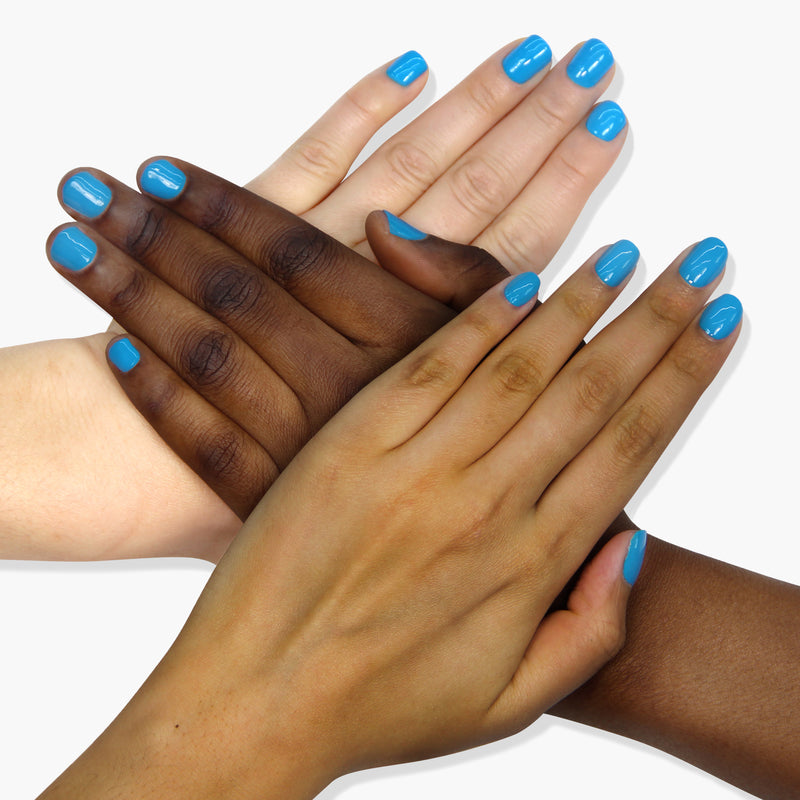 Four hands of different skin tones, with nails painted a bright neon blue using LONDONTOWN's "Cabana Boy" polish, overlapping in a crisscross pattern on a white background.