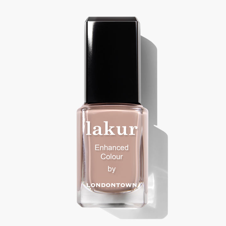 Bottle of Lakur Enhanced Colour nail polish by LONDONTOWN in the Café Au Lait shade, a light beige, creamy taupe, on a white background. This vegan, cruelty-free formula is Florium Complex Infused for added nourishment.