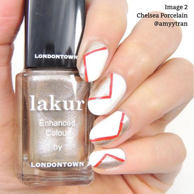 Hand holding a bottle of LONDONTOWN's Chelsea Porcelain (Professional) vegan cruelty-free nail polish with a gold shade. Manicure features white nails with gold triangles and red outline accents. Text: "Image 2, Chelsea Porcelain (Professional), @amytyran.