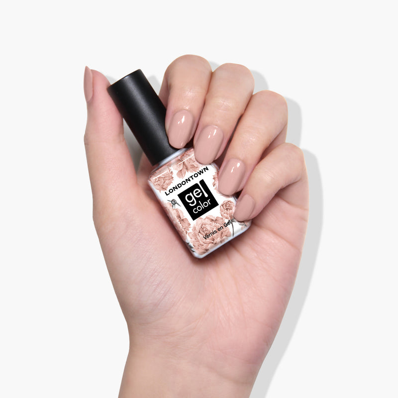 A hand with manicured nails holding a bottle of LONDONTOWN's Chiffon color gel nail polish, ideal for achieving a flawless gel color manicure that cures under UV/LED light.