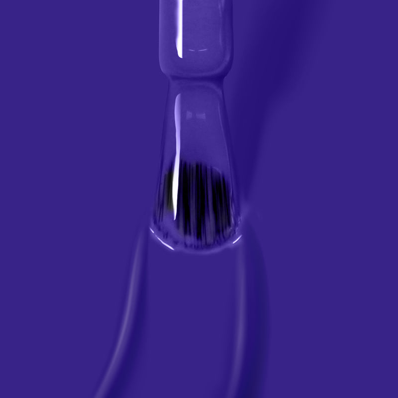 Close-up of a LONDONTOWN brush applying the vibrant purple crème shade "Cocktail Hour" nail polish on a surface, creating a smooth and glossy texture perfect for a gel manicure.