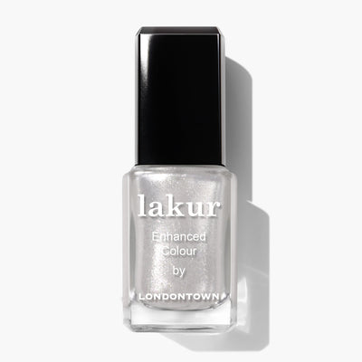 A bottle of "Coconut Crush (Professional)" by LONDONTOWN nail polish with a silver metallic finish and ultrafine glitter, featuring a black cap and clear rectangular bottle.