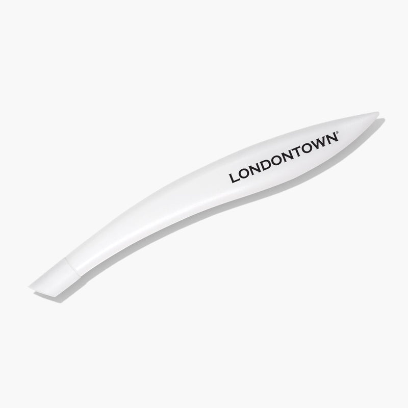A curved, white Cuticle Pusher from LONDONTOWN featuring the brand's name in black letters, set against a plain background—ideal for achieving salon-quality manicures and healthy-looking cuticles.