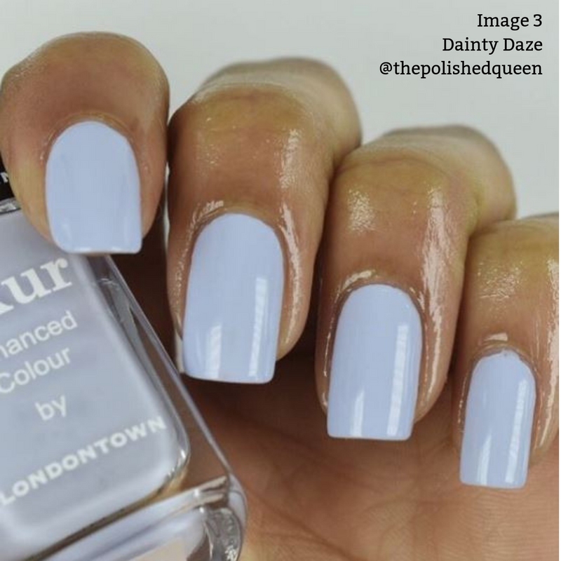 A close-up of a hand with periwinkle blue nail polish. The polish bottle is labeled "kur Enhanced Colour by LONDONTOWN." This vegan, cruelty-free formula boasts a 16+ Free composition. Image text reads: "Image 3 Dainty Daze @thepolishedqueen.