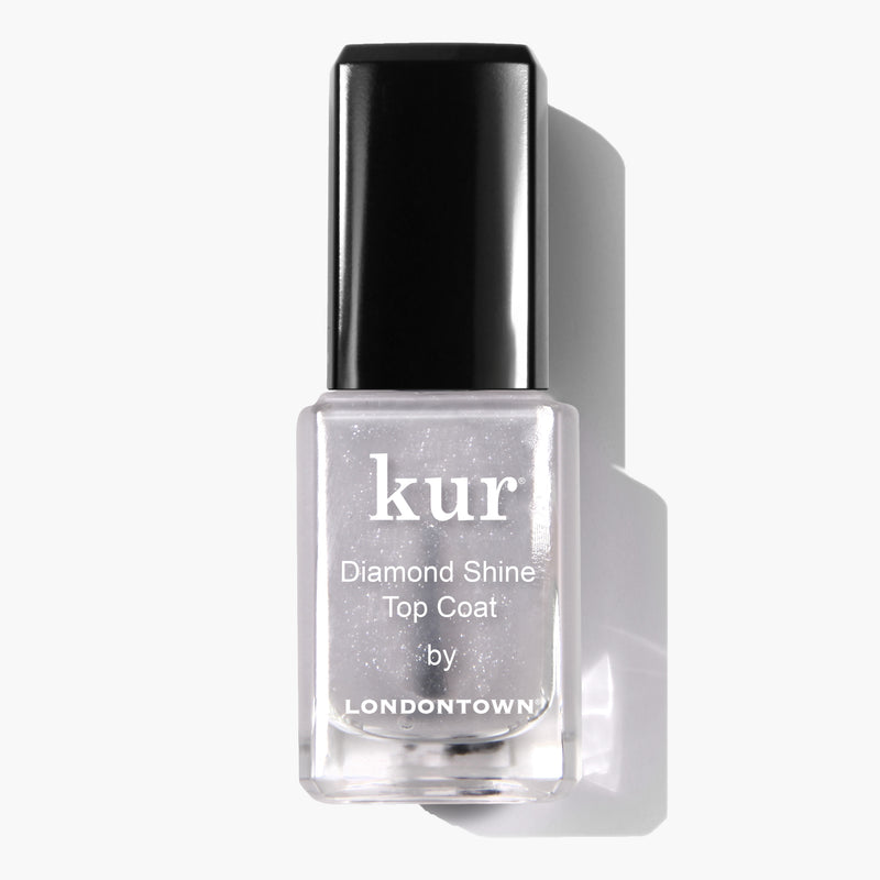 Clear bottle of LONDONTOWN Diamond Shine Top Coat nail polish with a black cap, labeled in white text. Infused with diamond-dusted particles, this top coat ensures extended wear and adds irresistible dimension to your manicure.