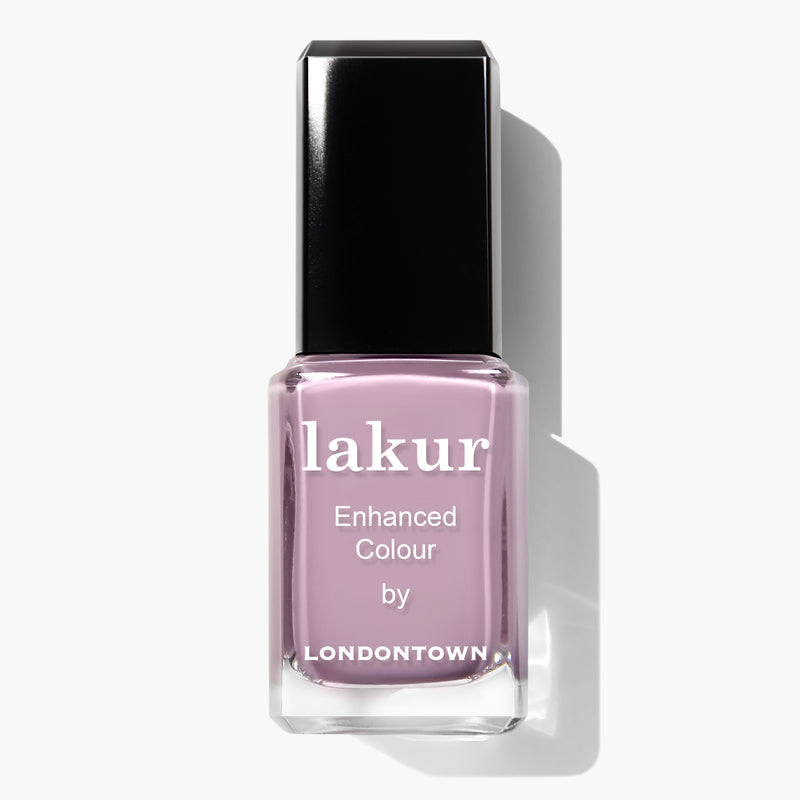 A bottle of Dolly Mix by LONDONTOWN, vegan cruelty-free nail polish in a light lavender shade with a black cap.