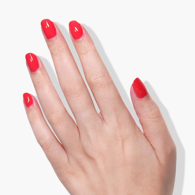 A hand with vibrant Down to Dilly hot pink crème nail polish by LONDONTOWN on all five fingernails is shown against a white background.