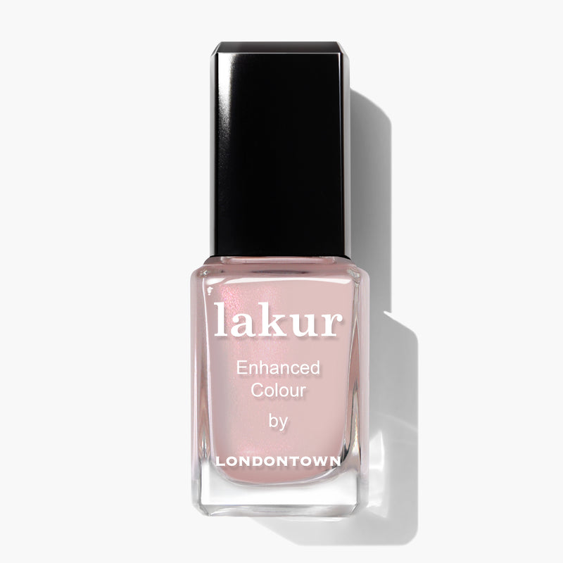 A bottle of LONDONTOWN Lakur nail polish labeled "Dream Scene" with an opalescent light pink shade and a shiny black cap, against a white background.