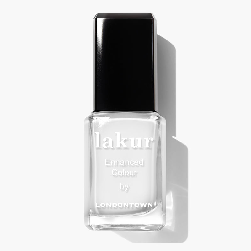 A bottle of LONDONTOWN's Duchess lakur Enhanced Colour nail polish, featuring a black cap and flaunting a pure crème white shade perfect for a French manicure, is shown against a white background.