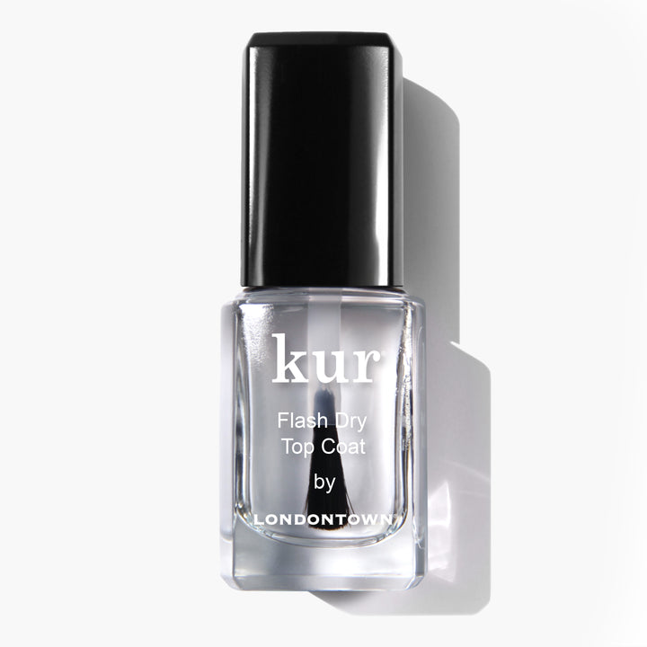 A bottle of LONDONTOWN Flash Dry Top Coat nail polish with a black cap, displayed against a plain white backdrop. This top coat provides a shine-enhancing, quick-drying finish for durable wear.
