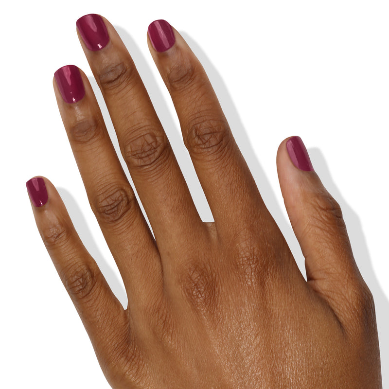 A hand with a Flirty & Thriving manicure from LONDONTOWN on short, well-groomed nails, set against a white background.