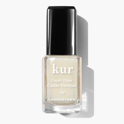Glass bottle with a black cap labeled "Fresh Glow Cuticle Remover (Professional) by LONDONTOWN," containing a translucent liquid, ideal for managing overgrown cuticles.
