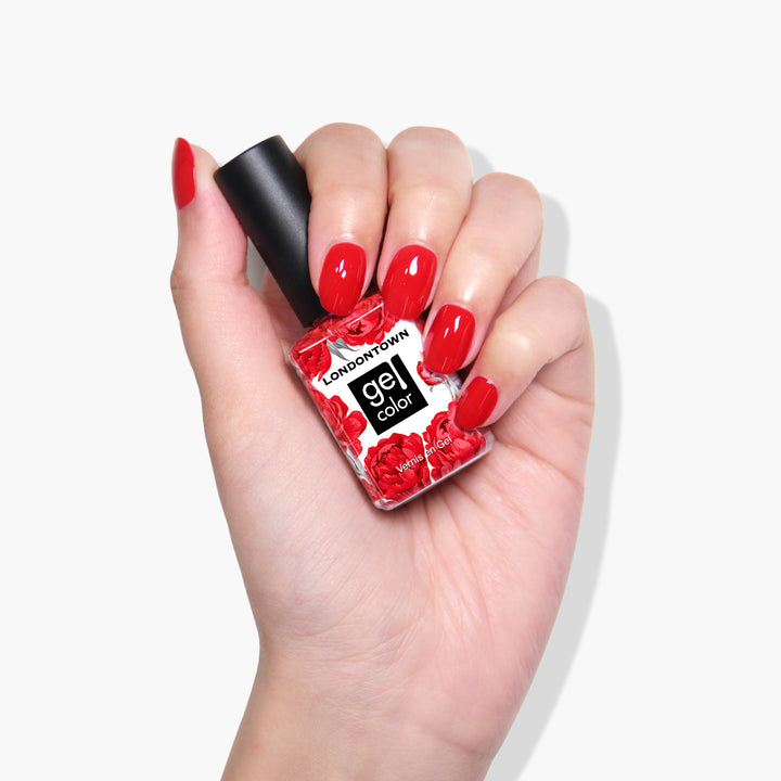 A hand holds a bottle of LONDONTOWN&