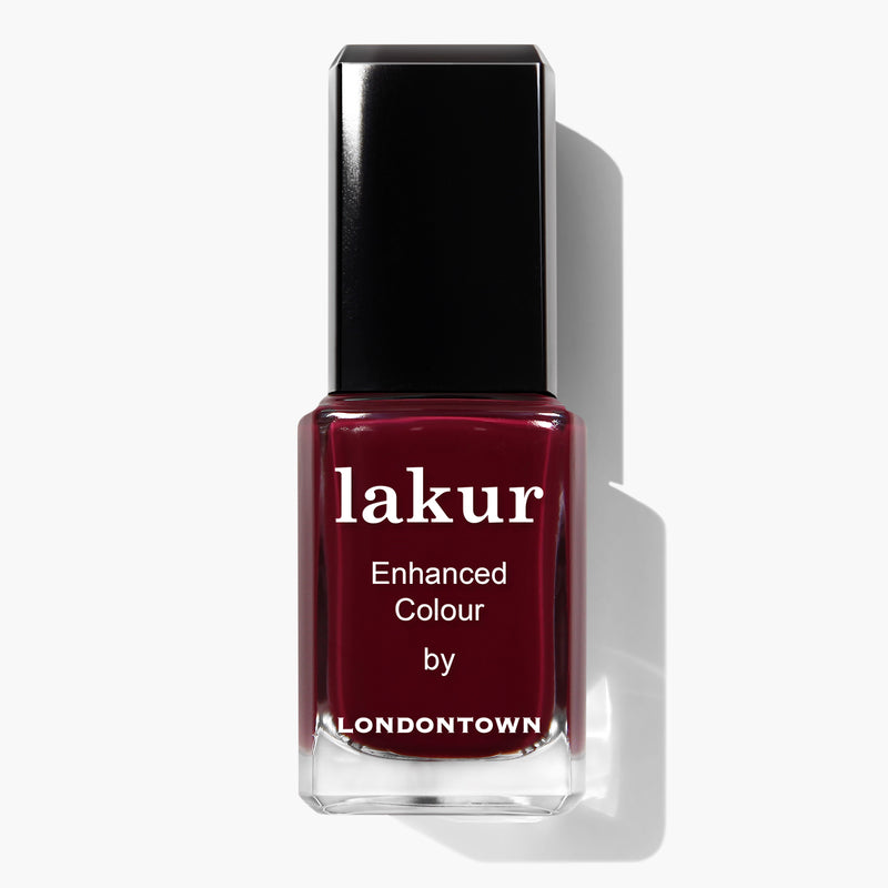 A bottle of Guarded Jewel nail polish by LONDONTOWN in a dark red color with a black cap and white text on the front, proudly vegan and cruelty-free.
