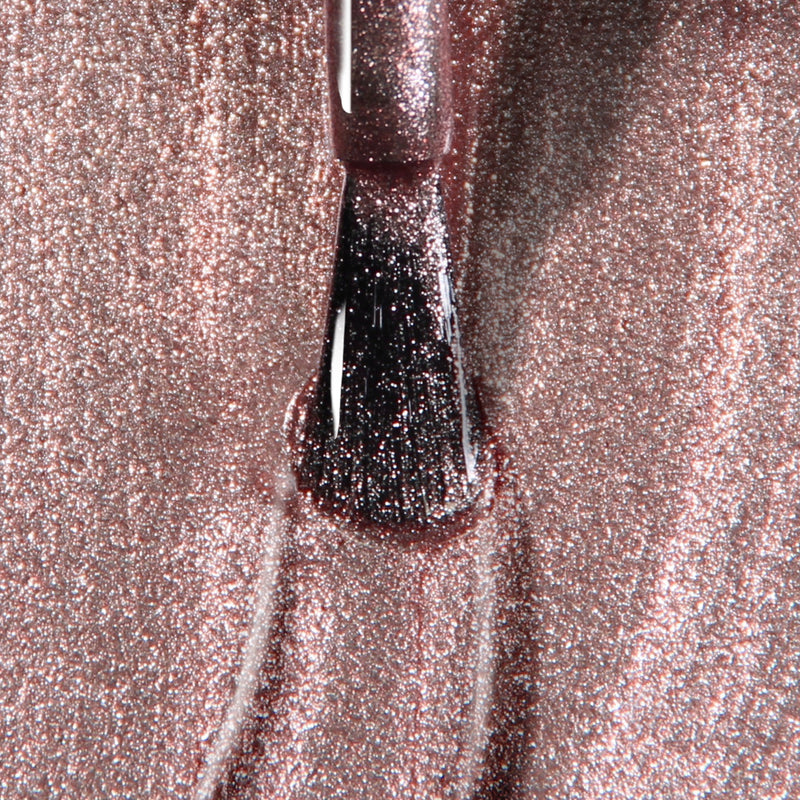 Close-up of a brush applying LONDONTOWN's Kissed by Rose Gold UV/LED Gel Color nail polish.