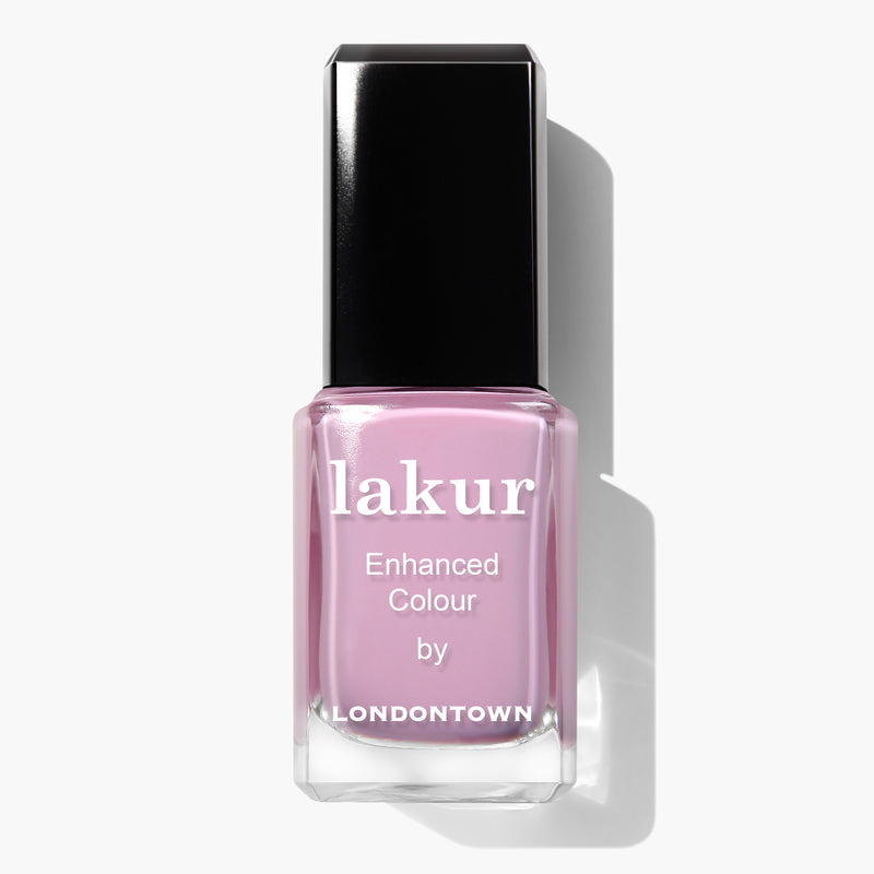 A bottle of Lemonade Pop lakur Enhanced Colour nail polish by LONDONTOWN in a muted pink shade. The cruelty-free and vegan formula comes in a bottle with a black cap.