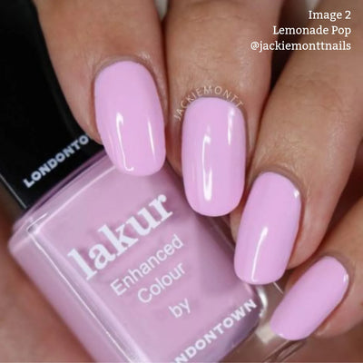 Close-up of a hand with manicured nails painted in a muted pink shade called "Lemonade Pop (Professional)" by LONDONTOWN. This vegan, cruelty-free, and formaldehyde-free polish is highlighted in the caption: "Image 2 Lemonade Pop (Professional) @jackiemonttnails.
