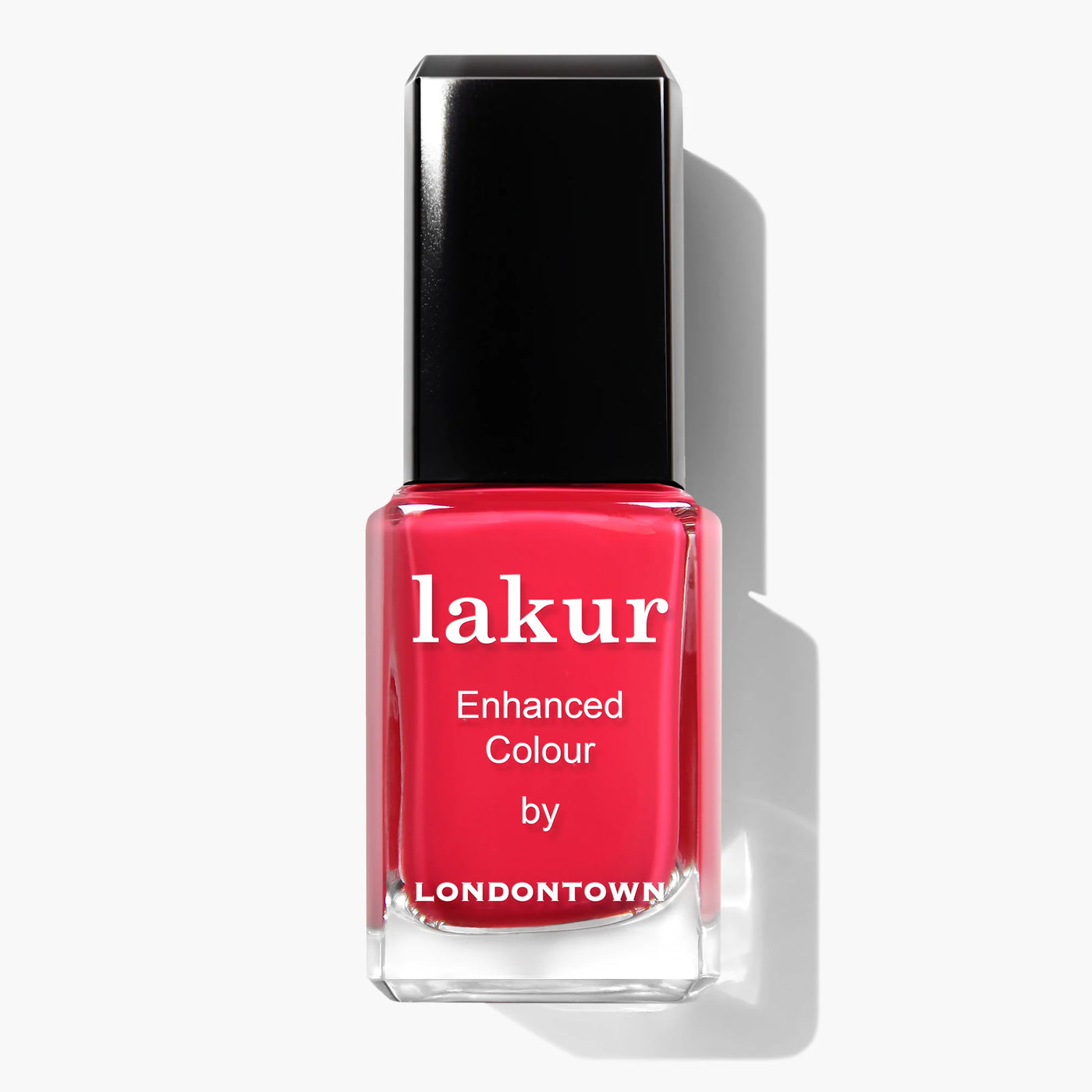 A rectangular glass bottle of London Calling (Professional) nail polish by LONDONTOWN, featuring a black cap. The vibrant red polish comes with a label that reads "lakur Enhanced Colour by LONDONTOWN." This vegan, cruelty-free nail polish ensures your nails look stunning without compromising on ethics.