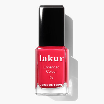 A rectangular glass bottle of London Calling (Professional) nail polish by LONDONTOWN, featuring a black cap. The vibrant red polish comes with a label that reads "lakur Enhanced Colour by LONDONTOWN." This vegan, cruelty-free nail polish ensures your nails look stunning without compromising on ethics.
